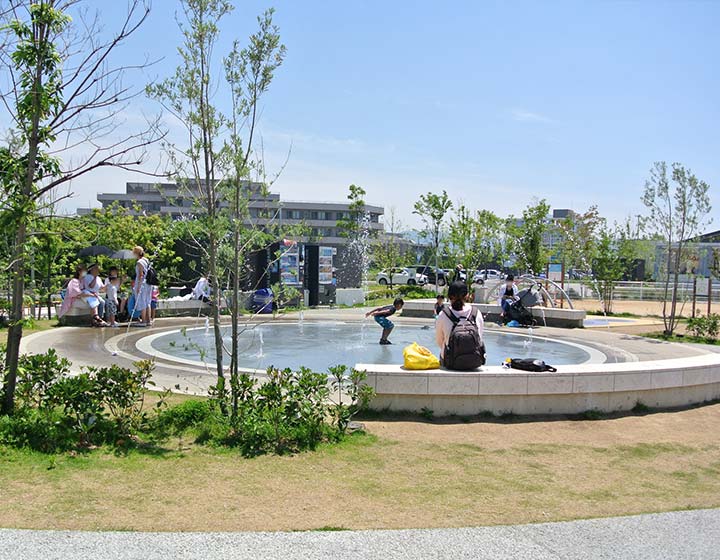 Many small children play in the fountain during the summer.