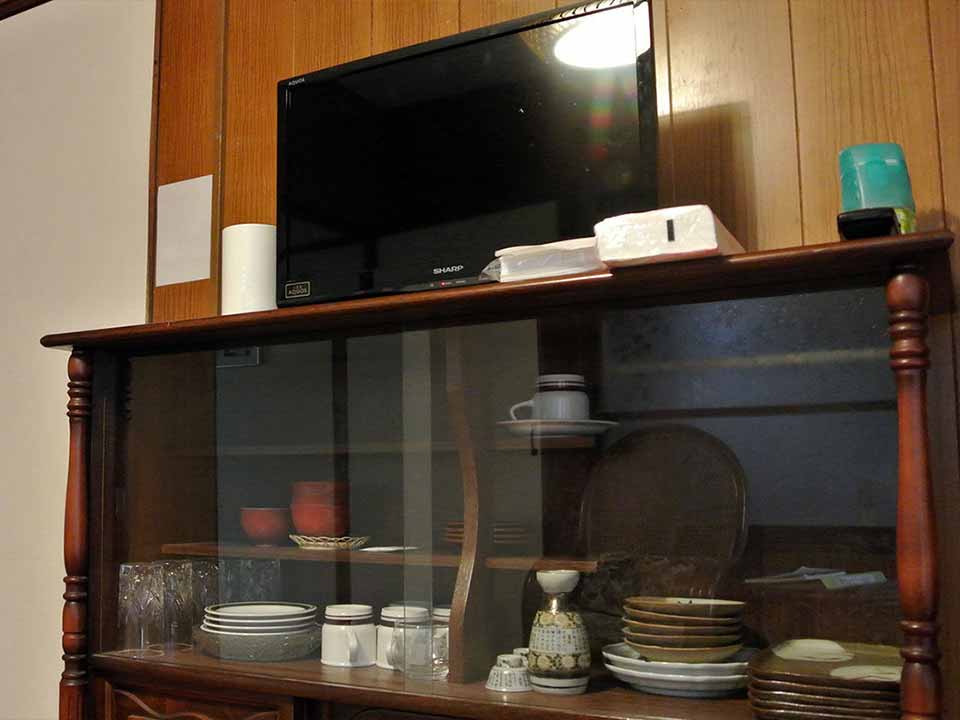 The shelf with the TV on it contains dishes. Please feel free to use it.